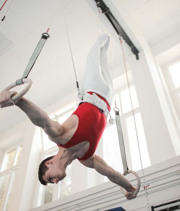 Man performing a controlled strength exercise with focus and calm determination.