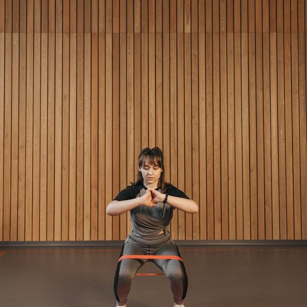 Neatly arranged yoga mats and resistance bands in a calm, minimalist studio.